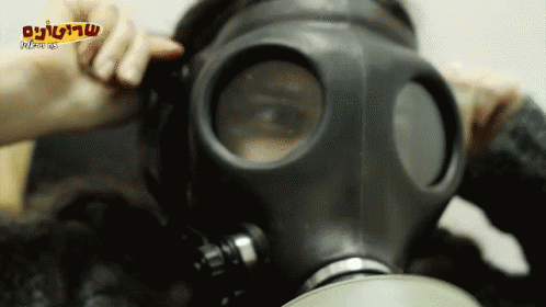 A Person Wearing A Gas Mask With A Foreign Language On The Bottom Right Corner GIF