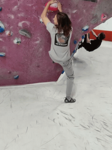 a person wearing a grey shirt that says enjoy the moment on the back