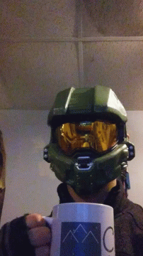 A Person Wearing A Halo Helmet Is Holding A Coffee Mug GIF