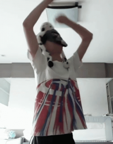 A Person Wearing A Hat And A T-Shirt With A British Flag Design On It GIF