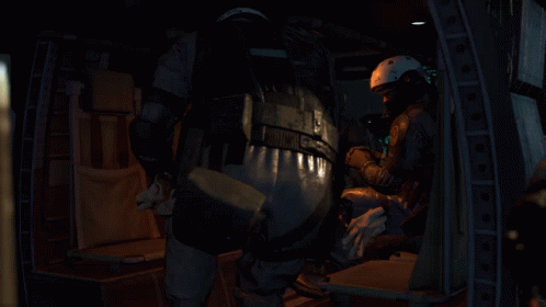 A Person Wearing A Helmet And A Microphone Is Sitting Down . GIF