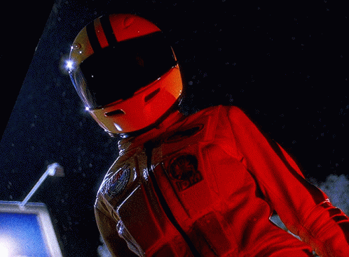 A Person Wearing A Helmet And A Red Jacket With A Patch That Says Nasa On It GIF