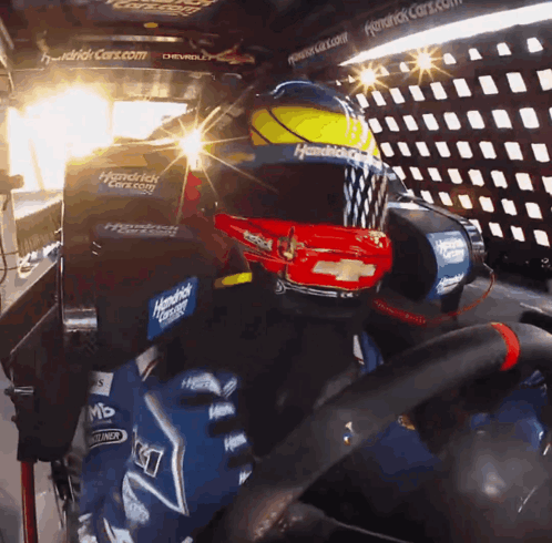 A Person Wearing A Helmet That Says Hendrick Racing On It GIF