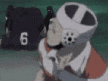 A Person Wearing A Helmet With The Number 6 On It Is Talking On A Cell Phone . GIF