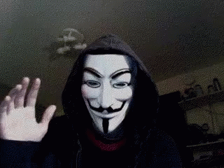 A Person Wearing A Hooded Jacket And A Anonymous Mask Is Waving GIF