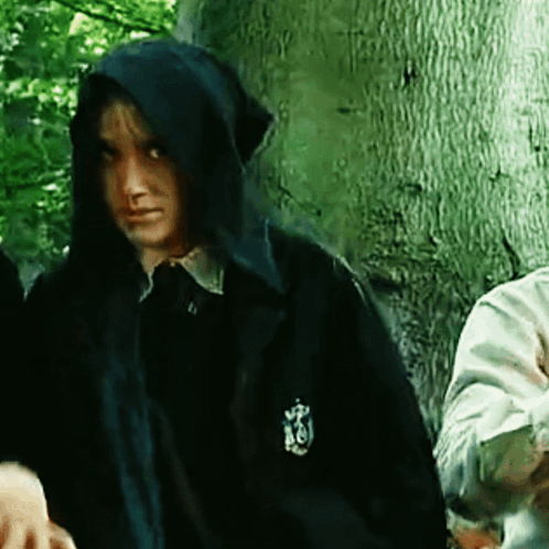 A Person Wearing A Hooded Jacket With A Crest On The Sleeve GIF