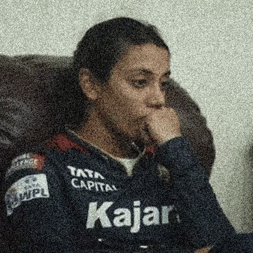A Person Wearing A Kajar Shirt Is Sitting In A Chair GIF