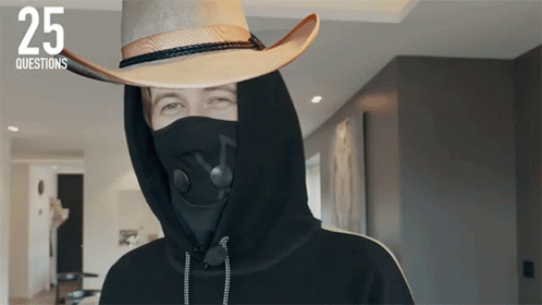 a person wearing a mask and a cowboy hat with the number 25 on the bottom