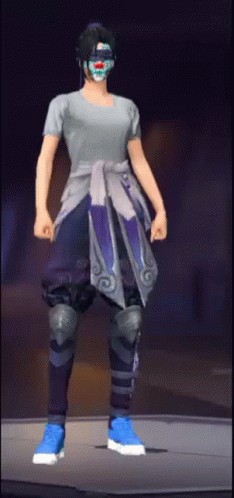A Person Wearing A Mask And A Gray Shirt Is Standing On A Stage . GIF