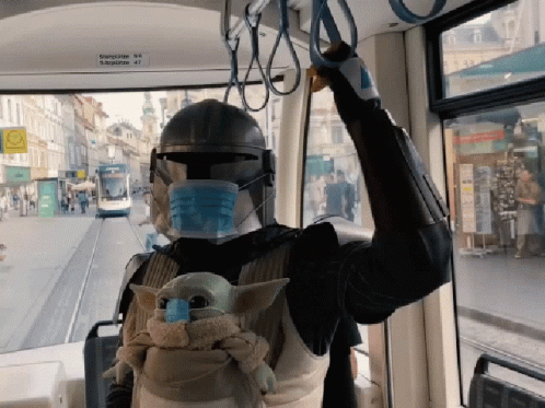 A Person Wearing A Mask And A Helmet Is Riding A Bus With A Sign That Says ' Bahnhof ' On It GIF