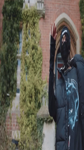A Person Wearing A Mask And A Jacket That Says ' Supreme ' On It GIF