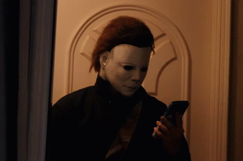 a person wearing a mask is looking at their phone