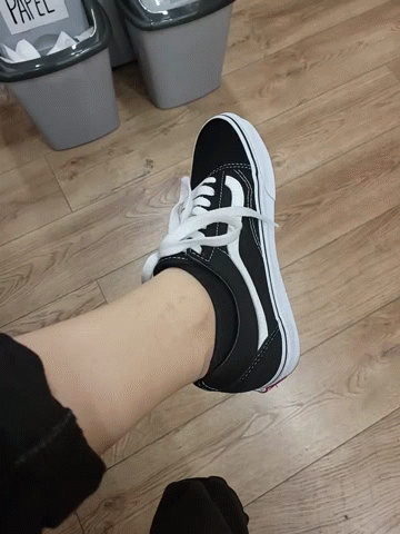 A Person Wearing A Pair Of Black And White Sneakers GIF