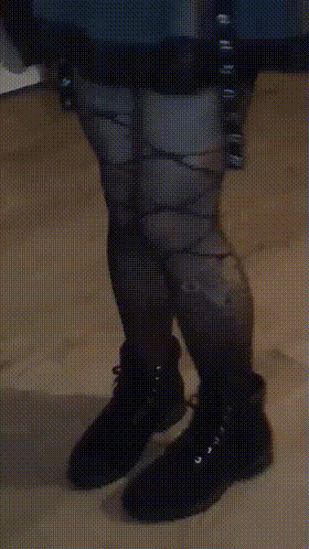 A Person Wearing A Pair Of Black Boots With A Pattern On Them GIF