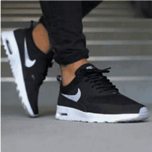 A Person Wearing A Pair Of Black Nike Air Max Thea Sneakers GIF