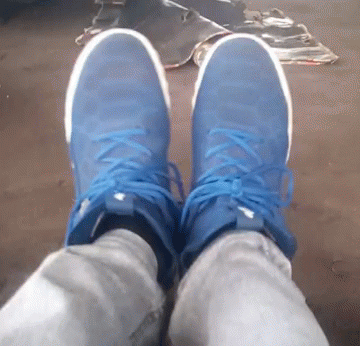 A Person Wearing A Pair Of Blue And White Sneakers GIF
