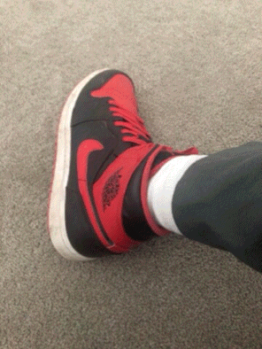 A Person Wearing A Pair Of Red And Black Air Jordans GIF