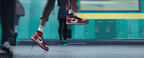 A Person Wearing A Pair Of Red And White Nike Air Jordans GIF