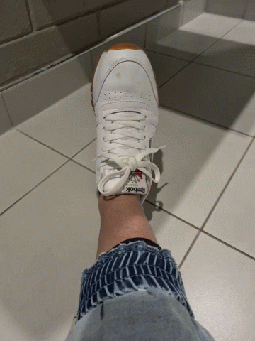 A Person Wearing A Pair Of Reebok Sneakers GIF