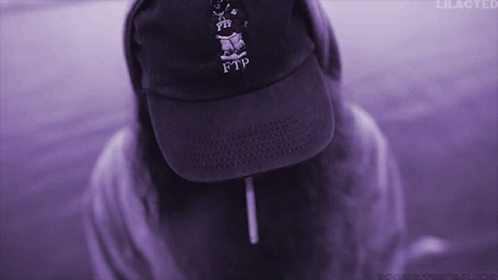 A Person Wearing A Purple Ftp Hat And A Purple Background GIF