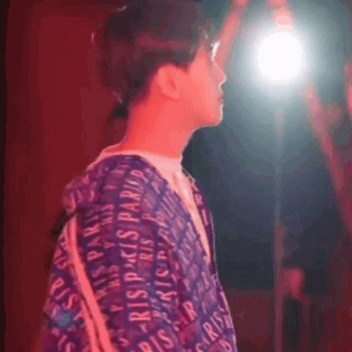 A Person Wearing A Purple Shirt That Says Paris GIF