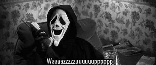 A Person Wearing A Scream Mask Is Talking On A Cell Phone . GIF