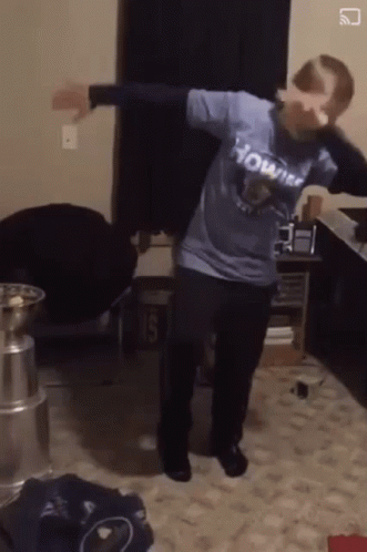 A Person Wearing A Shirt That Says Howitzer Is Dancing In A Room GIF