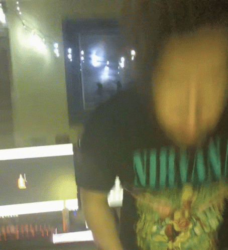 A Person Wearing A Shirt That Says Nirvana On It GIF
