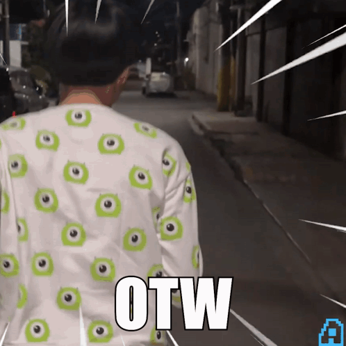 A Person Wearing A Shirt With Green Eyes And The Word Otw On The Back GIF