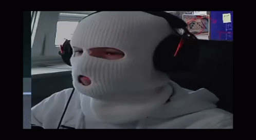 A Person Wearing A Ski Mask And Headphones Looks At The Camera GIF