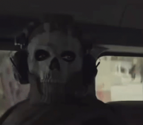 A Person Wearing A Skull Mask With Headphones On Their Head GIF