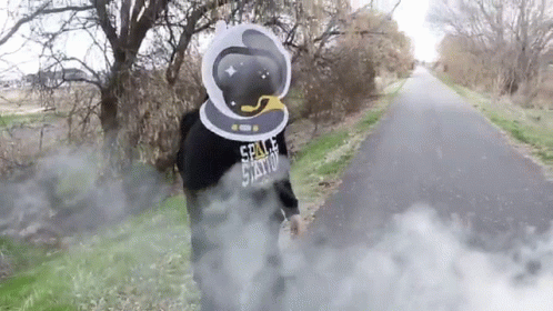 A Person Wearing A Space Station Hoodie Is Standing On A Road GIF