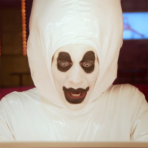Person In White Hooded Costume With Black Eyes GIF