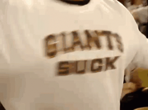 A Person Wearing A White Shirt That Says Giants Suck On It . GIF