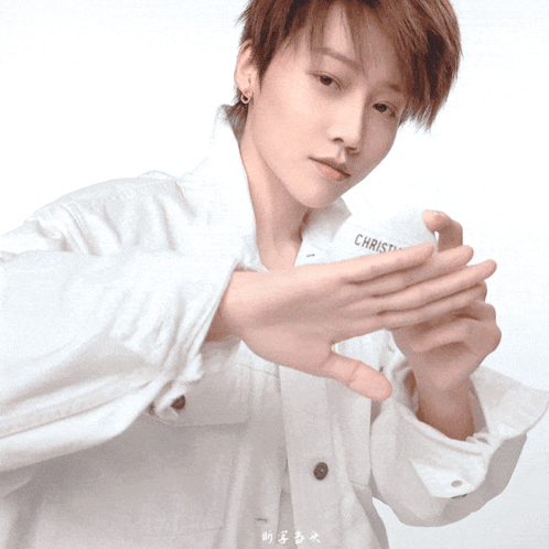 A Person Wearing A White Shirt With The Word Christ On The Front GIF
