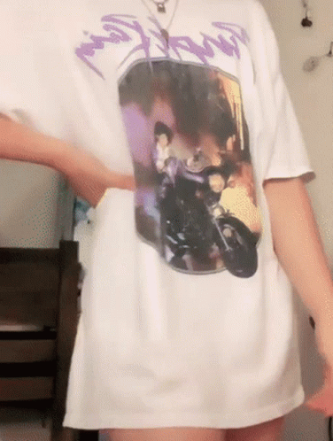 A Person Wearing A White T-Shirt With A Picture Of A Man On A Motorcycle On It GIF