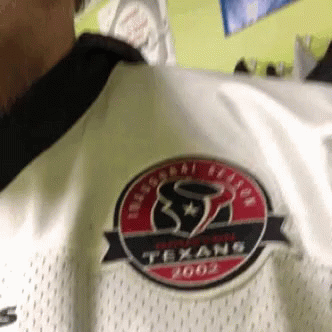A Person Wearing A White Texans Jersey With A Red And Black Logo GIF