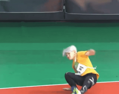 A Person Wearing A Yellow Shirt With The Number 1 On The Front GIF