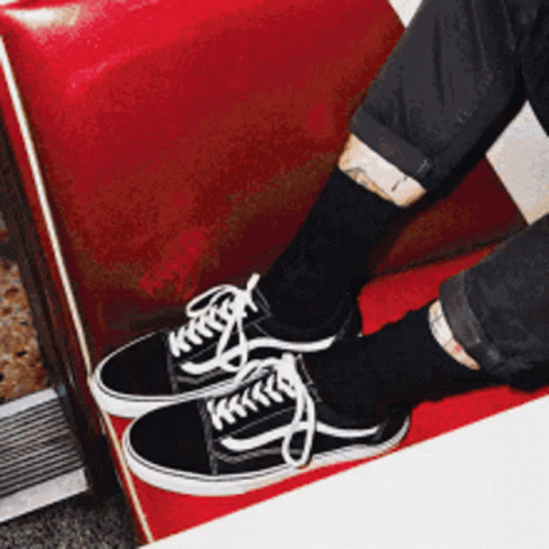 A Person Wearing Black Socks And Black Vans Sneakers GIF