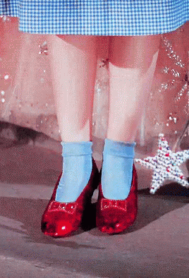 A Person Wearing Blue Socks And Red Shoes With A Bow GIF