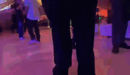 a person wearing green pants is standing on a ice rink