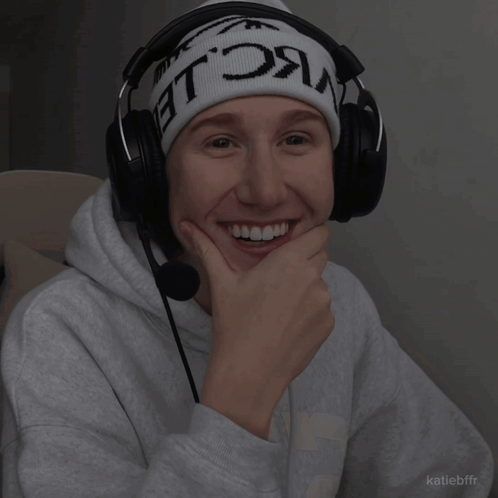 a person wearing headphones and a beanie that says ' nc le ' on it