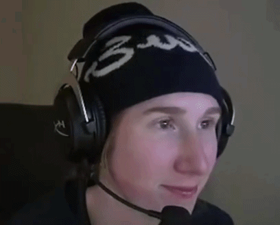 a person wearing headphones and a beanie with the number 3 on it is smiling .