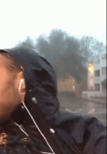 A Person Wearing Headphones And A Black Jacket With A Hood On GIF
