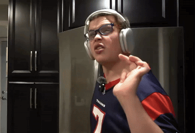 A Person Wearing Headphones And A Texans Jersey GIF
