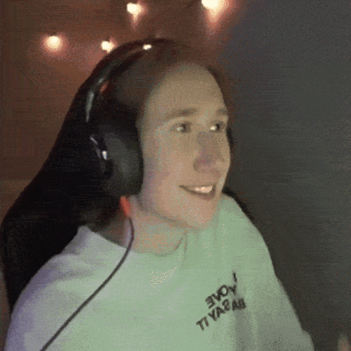 a person wearing headphones and a white shirt that says evoy
