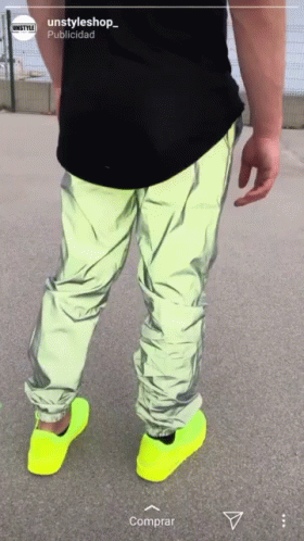 A Person Wearing Neon Yellow Shoes And A Black Shirt With The Words Unstyleshop On The Bottom GIF