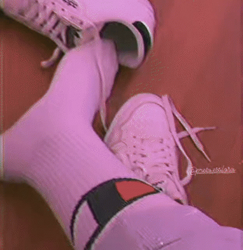 a person wearing purple socks and white sneakers