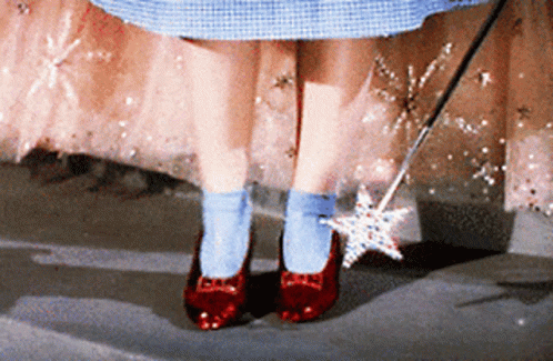 A Person Wearing Red Shoes And Blue Socks With A Wand GIF
