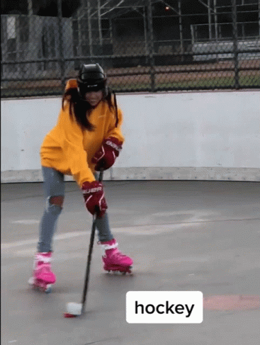 A Person Wearing Roller Skates And Hockey Gloves GIF